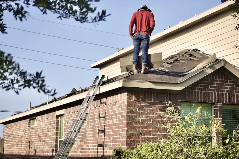 Professional roofer working on a residential roof in Little Nahant